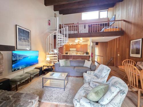 a living room with a couch and a tv at Spiral Staircase home in Kings Beach