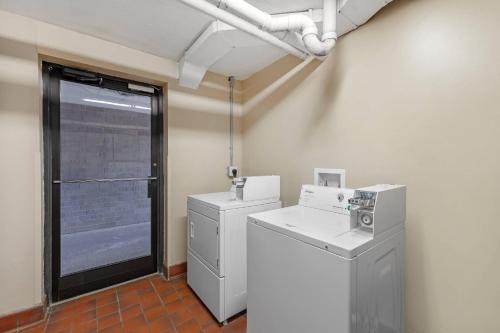 a laundry room with a washer and dryer and a window at Quality Inn Columbus, MS in Columbus