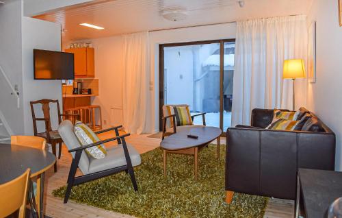 a living room with a couch and a table at 3 Bedroom Nice Home In Simrishamn in Simrishamn