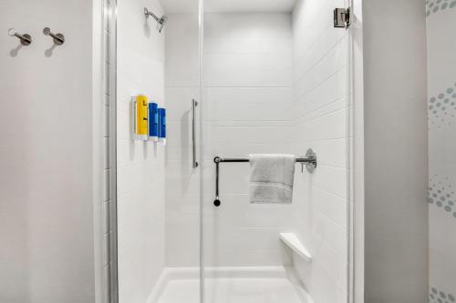 a white bathroom with a shower with a glass door at Tru By Hilton Augusta Washington Road in Augusta