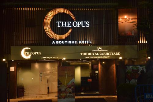 a sign for the oxus a boutique hotel at night at The Opus Kolkata - A Boutique Hotel in Kolkata