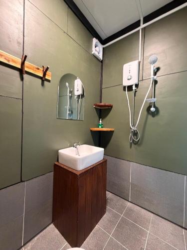 a bathroom with a sink and a mirror at Sand and Sun Koh Rong in Kaôh Rŭng