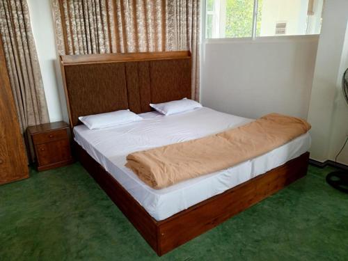 a bedroom with a bed in a room with a window at Smart heritage in Galaha Town