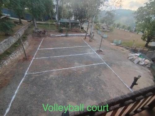 a tennis court in the middle of a park at Smart heritage in Galaha Town