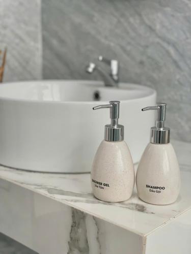 a bathroom with two soap dispensers on a counter at Bắp Villa Huế in Thôn Lại Thê