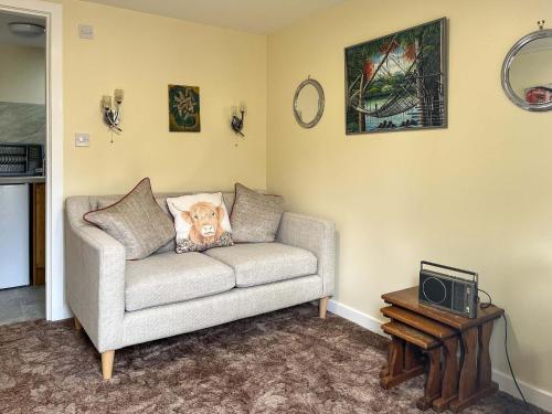 a living room with a couch with a stuffed animal on it at The Stable Room - Uk51595 in Berwick-Upon-Tweed