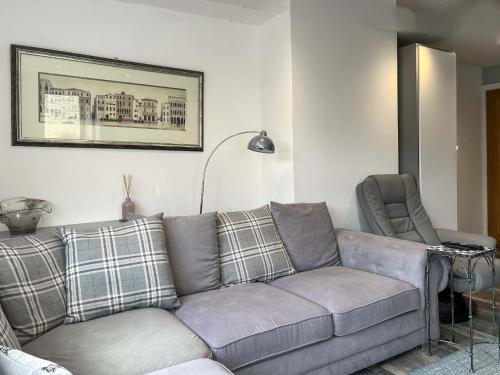 a living room with a couch and a chair at Peebles Apartment in Peebles