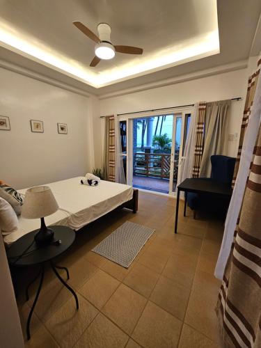 a bedroom with a bed and a couch and a window at Punta Private Beach Resort in San Teodoro