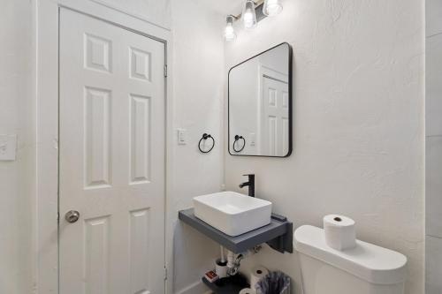 a white bathroom with a sink and a mirror at 2BR Apt 3 mins Paseo, 8 mins Downtown, Unit 2 in Oklahoma City
