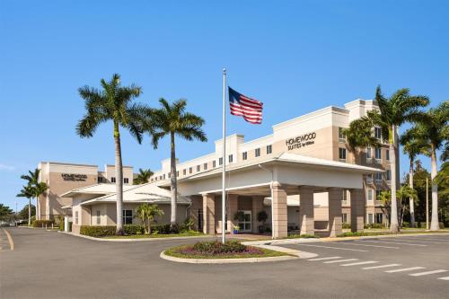 an american flag flying in front of a building at Homewood Suites Fort Myers Airport - FGCU in Fort Myers
