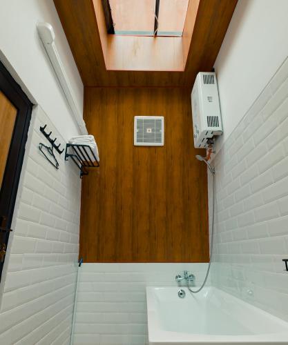 a bathroom with a sink and a ceiling at Pakuhaji Highland Ecoresort in Panjadakan