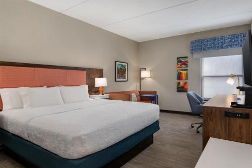 a hotel room with a bed and a desk at Hampton Inn Eden in Eden