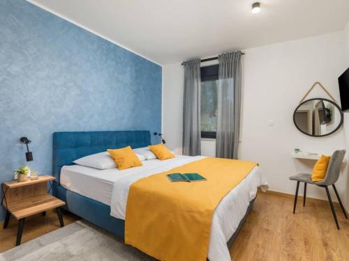 a bedroom with a large bed with a yellow blanket at Villa Giulia by IstriaLux in Manjadvorci