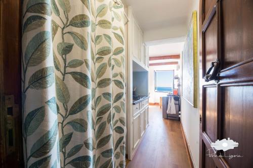 a hallway with a curtain with leaves on it at La cabina del capitano in Bogliasco