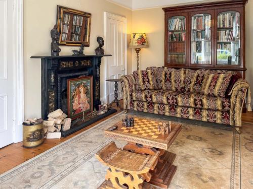 a living room with a couch and a chess board at Embleton House - Uk51597 in Berwick-Upon-Tweed