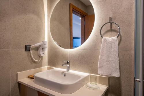 a bathroom with a sink and a mirror at Orkide Bodrum in Bodrum City