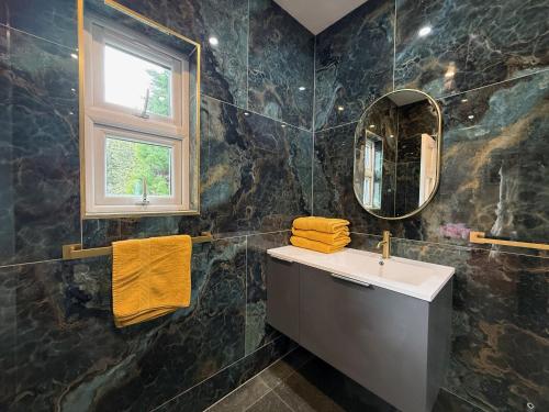 a bathroom with a sink and a mirror at Shannon River House & Gardens in Limerick