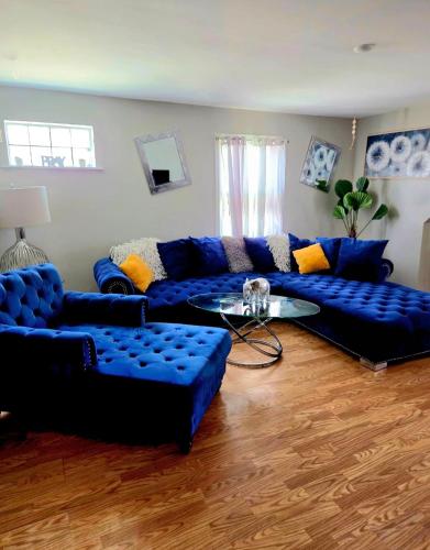 a living room with blue couches and a glass table at Comfortable & Relaxing Charming 3BR unit in Chicago