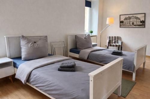 a bedroom with two beds with pillows on them at Fortuna Inn Salzmünde in Salzatal