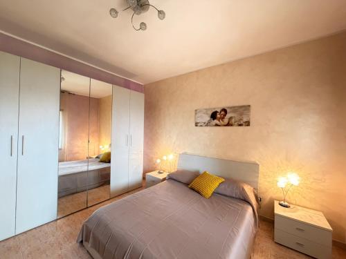 a bedroom with a bed and a mirror at Tra Mare e Relax in Gallipoli