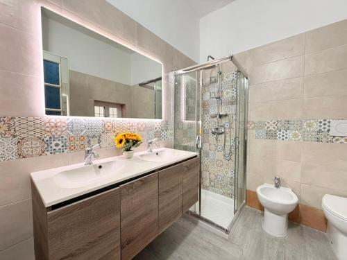 a bathroom with a sink and a toilet and a mirror at Tra Mare e Relax in Gallipoli
