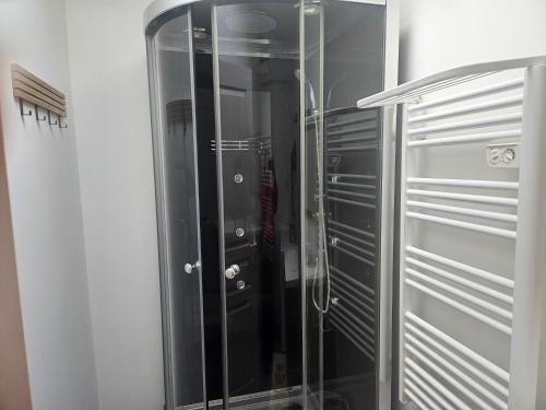 a glass walk in shower in a room at Gîte Les Durands in Cahors