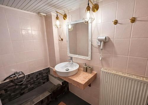 a bathroom with a sink and a mirror at Vintage Home in Ouranoupoli