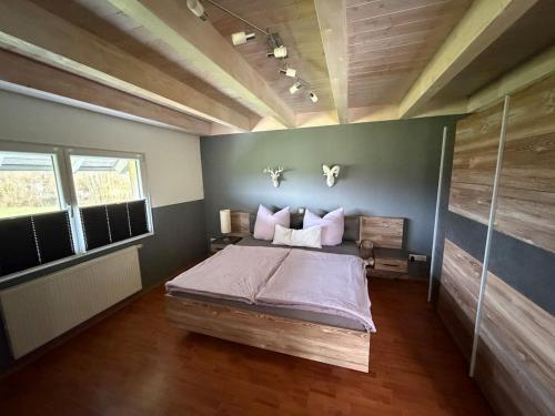 a bedroom with a large bed in a room at Black Forest Sports Loft in Achern