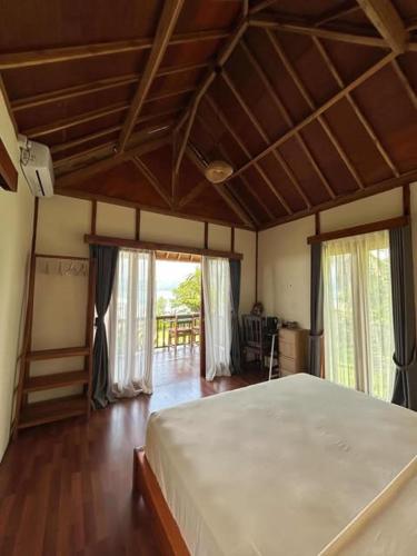 a bedroom with a large bed in a room at Yellow Coco Gili Gede in Gili Gede