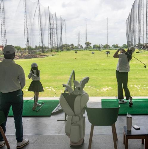 a group of people playing a game of golf at Clover Greens Golf Course & Resort - Attibele, Hosur in Sarjāpur
