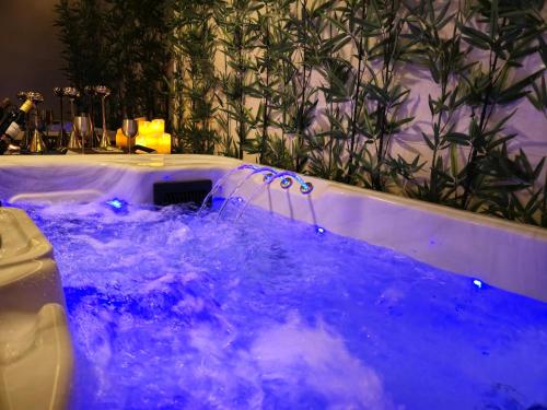 a jacuzzi tub with blue water in a room at Hotel Atrium Jongno in Seoul
