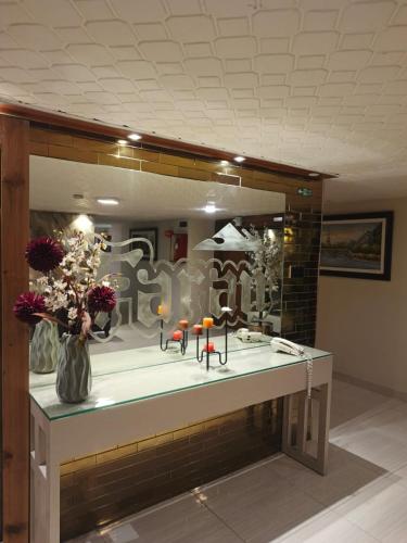 a bathroom with a sink and a large mirror at Faran Hotel in Karachi