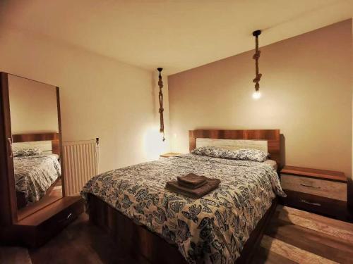 a bedroom with a bed and a large mirror at Cozy & Modern Flat for 5 in Athens in Athens