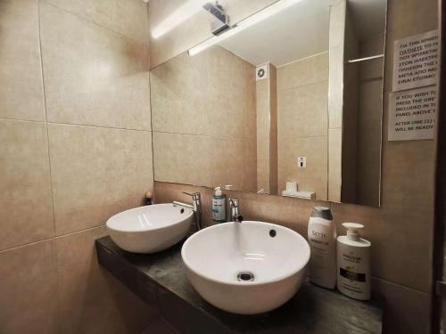 a bathroom with a sink and a mirror at Cozy & Modern Flat for 5 in Athens in Athens