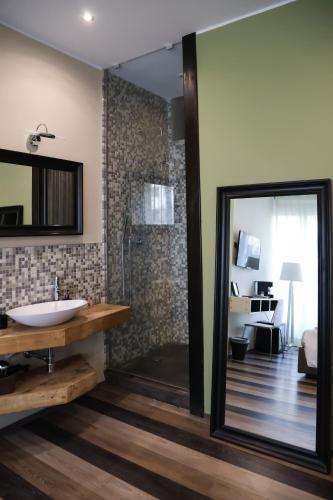 a bathroom with a sink and a glass shower at Serendipity Rooms in Milan