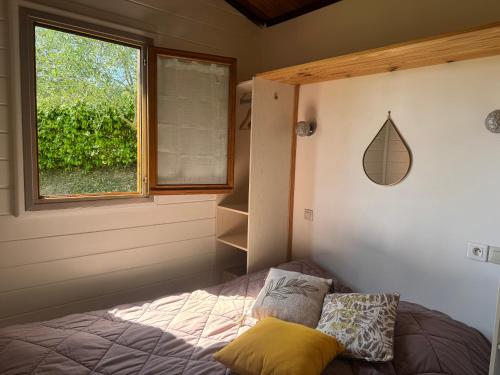 a bedroom with a bed and a window at Au Pays de Cocagne in Nyons