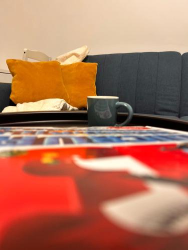 a coffee table with a coffee cup on top of it at Yellow Dawn Modern Flat in Quiet Area with Garage Parking and Self Check-In in Rediu