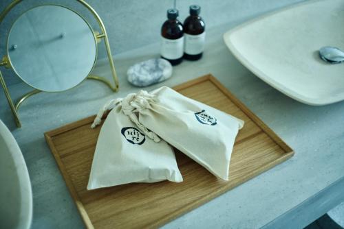 a counter with two towels on a cutting board next to a sink at Hiire IZU OLIVE in Ito