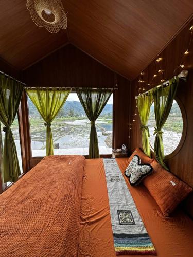 a bedroom with a large bed with a large window at An's House homestay & Hagiang local tours in Ha Giang