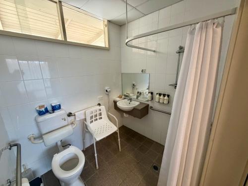 a bathroom with a toilet and a sink at Ashwood Motel in Gosford