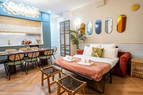 a room with a bed and a table and chairs at Sophie Stay - Le Mucha - King size bed - AC in Paris