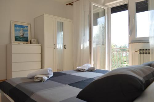a bedroom with two towels sitting on a bed at Anka Cozy Apartment in Galovac