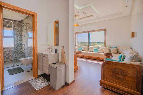 a bathroom with a sink and a toilet in a room at Villa moderne à 5 min de la plage avec jardin et 3 salons in Essaouira