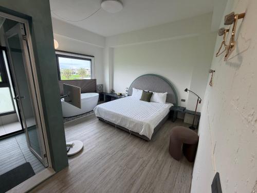a bedroom with a bed and a tub and a sink at MM No6 Villa in Luodong
