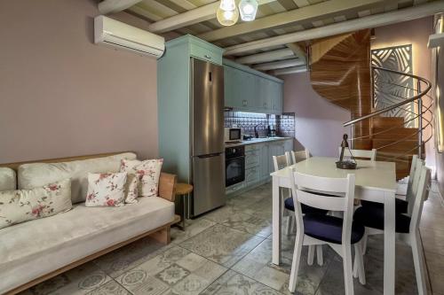 a living room with a couch and a table and a kitchen at Vetus Oppidum Boutique Guesthouse in Chania