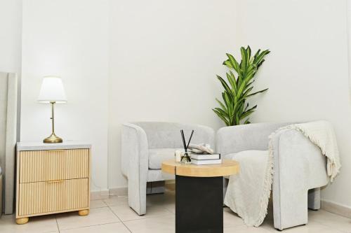 a living room with a couch and a table at Bloomfields Studio Emirates Cluster 24 Intl. City in Dubai