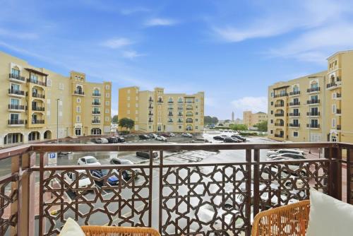 a balcony with chairs and a view of a parking lot at Bloomfields Studio Emirates Cluster 24 Intl. City in Dubai