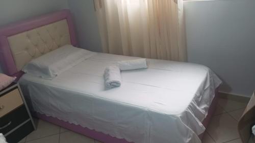 a small bed with a towel on top of it at Refika in Berat