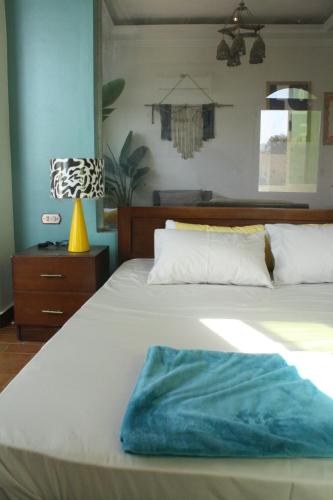 a bedroom with a bed with a blue towel on it at Tecoma studios Lighthouse in Dahab