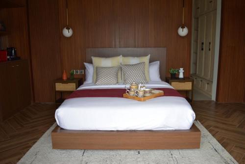a bedroom with a large bed with a tray on it at Brio de Agoho Zambales by Cherry in Candelaria